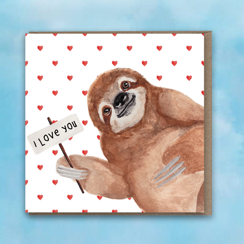 Greeting card featuring a painted sloth holding a sign saying I love you and a red heart background