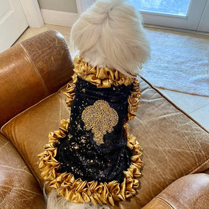 Exquisitely crafted by C’Mimi’s world-renowned pet fashion Designer Jan Ben with the finest details, this regal dog dress features glittering black and silver sequins, an ornate gold beaded and bejeweled centerpiece applique, and stunning gold satin ruffles on the neckline, midline and skirt.