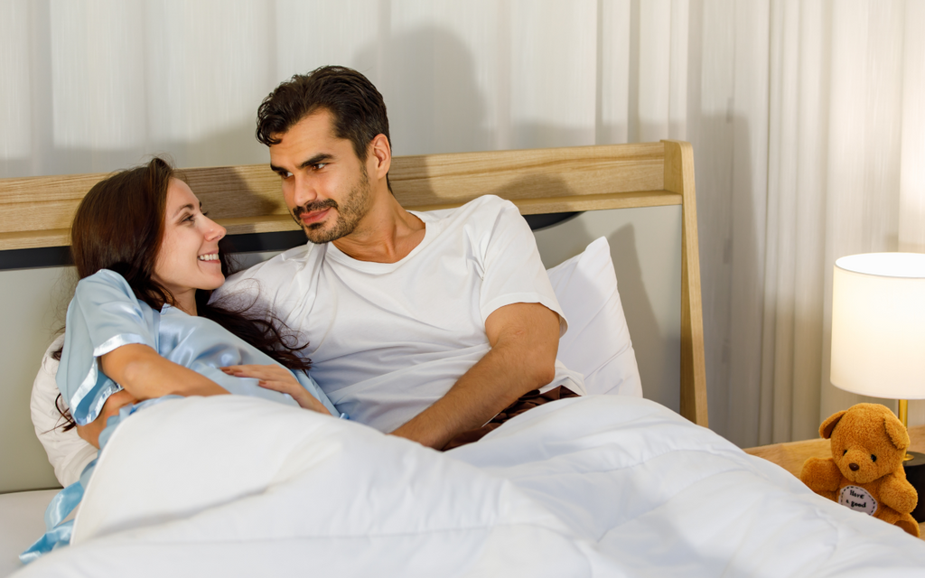 Couple talking in bed