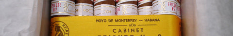 Open box of Hoyo de Monterrey premium cigars, revealing cigars inside.