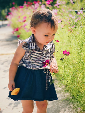 Maya smelling flowers