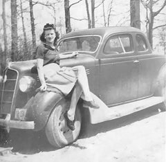 Image of Edythe, a woman sitting on a vintage car