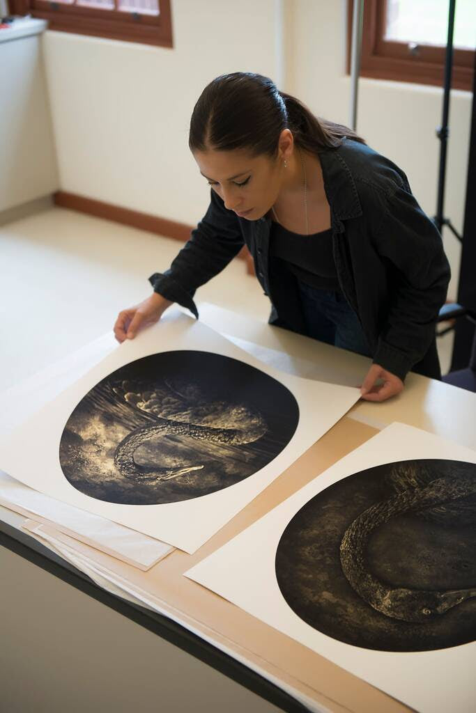 Eva Fernanez in her studio with 'A Rare Bird in the Lands' prints