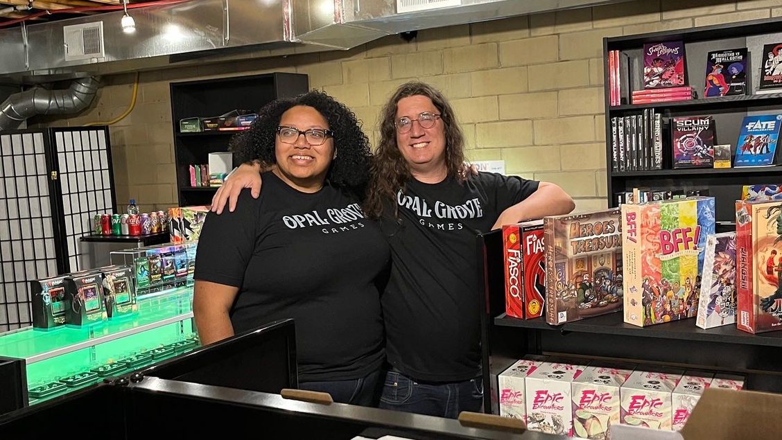 Aisha and Ben standing proudly in front of the dice display