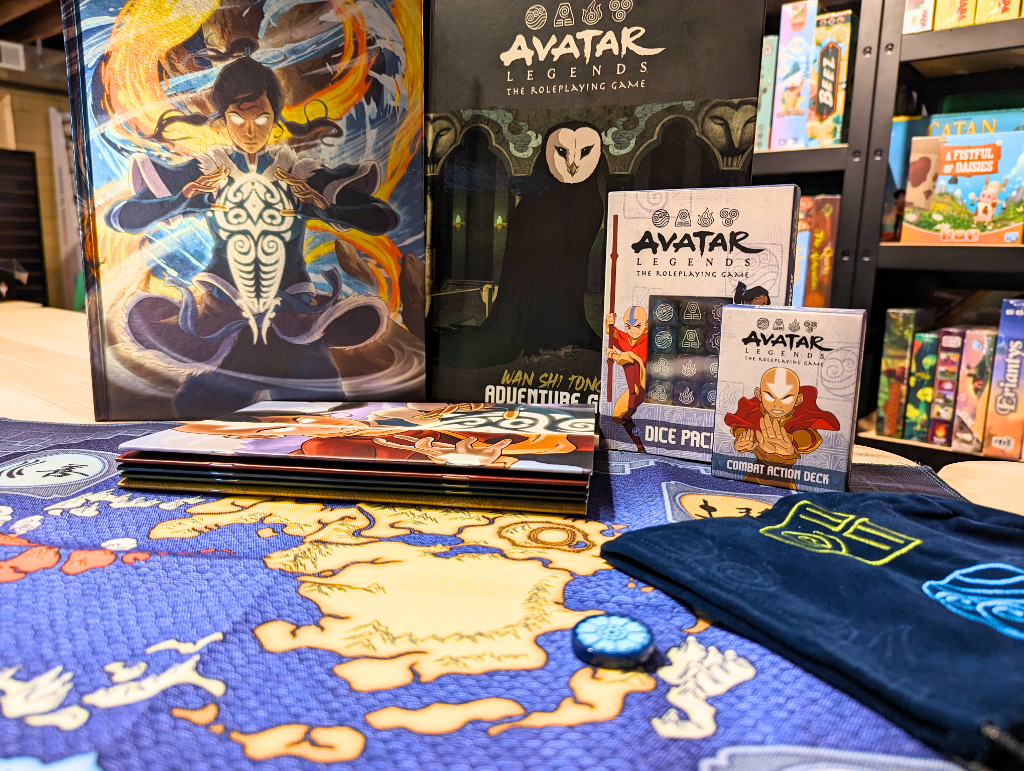 Avatar roleplaying game bundle including special core rulebook with foil cover, supplementary adventure guide, custom dice, dice bag, playmat, and journal set