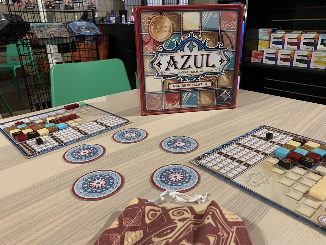 end state of a close game of Azul: Master Chocolatier showing off a new burgundy, cream, and blue chocolate theme