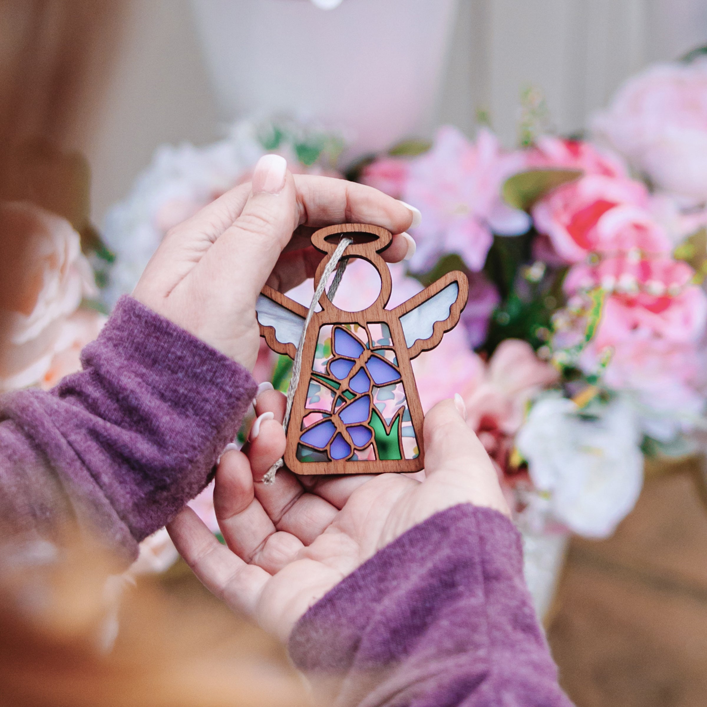 Someone who is grieving lovingly holds a purple butterfly memorial gift.