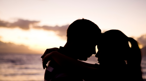 couple intimate during sunset