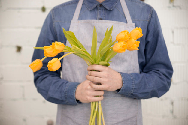 Florist Presenting a yellow flower for grand opening