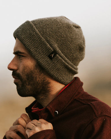 A man wearing a brown Anian Cashmere Toque outdoors