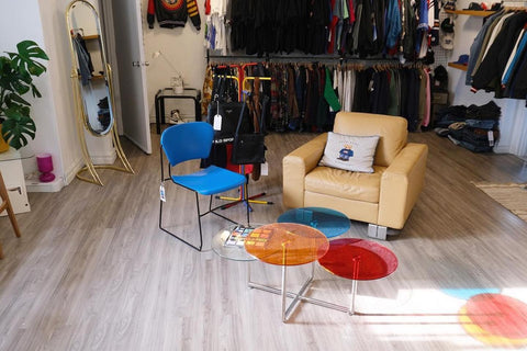 Une image à l'intérieur du magasin de vêtements vintage Reiyee, avec un ensemble de chaises et une table à l'avant