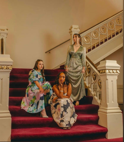 three women on the stairs of Music Hall
