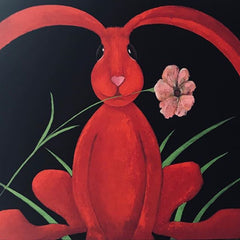 A bright painting of a funky red rabbit with a flower in its mouth, on a black background, by artist J Lyn Henderson