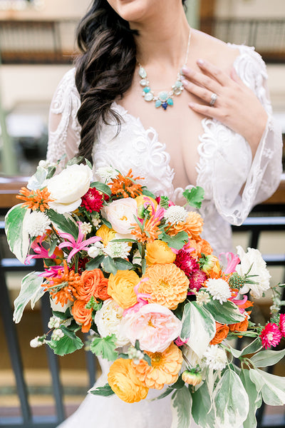 bride holding spring orange bridal bouquet