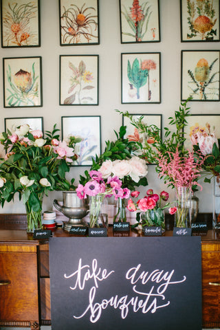 pink, green, and hot pink flower bar with take away bouquet sign on the front of it