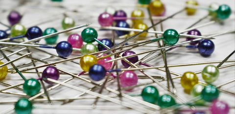 assorted color of floral pins in pile on table