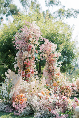 floral arch and walkway with light pink and blush fresh flowers for outdoor wedding