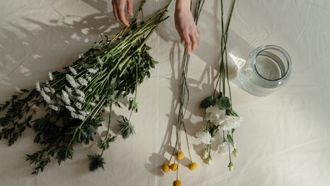 someone arranging flowers on a table