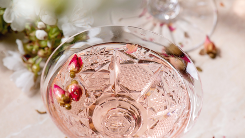 glass of pink champagne up close on table