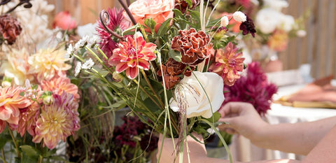 guest creating bouquet with neutral flowers