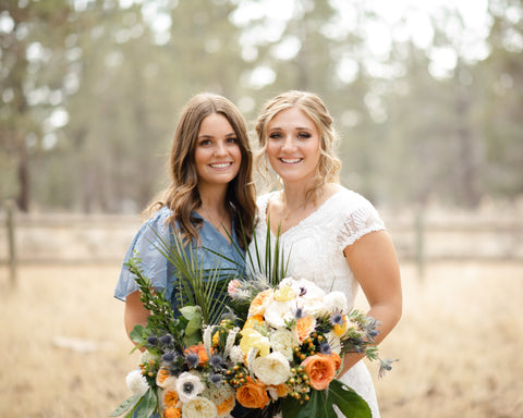 bride with maid of honor holding bouquets