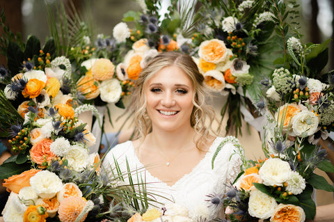 bride surrounded by her bridesmaids bouquets