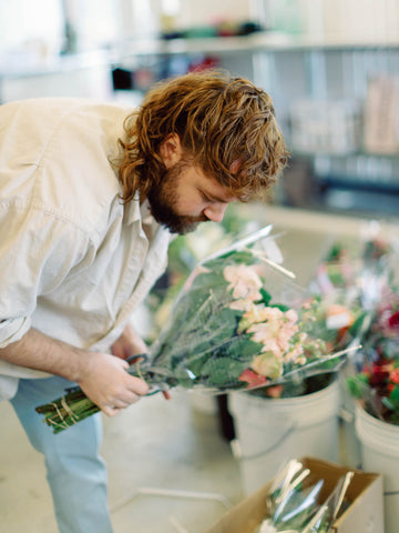 man processing flowers for a wedding following proper flower care steps