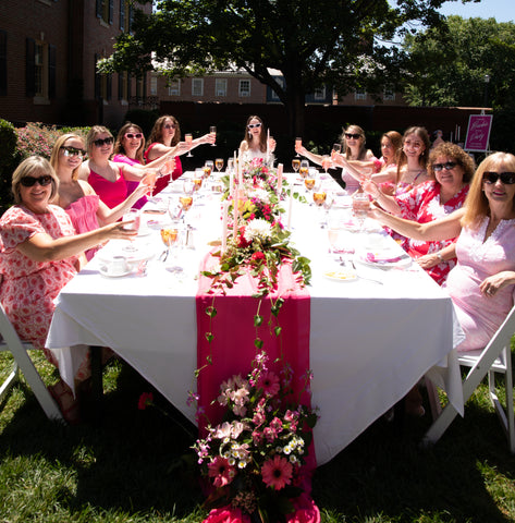 Barbiecore Wedding Inspiration Barbie bridal brunch with guests sitting at pink table