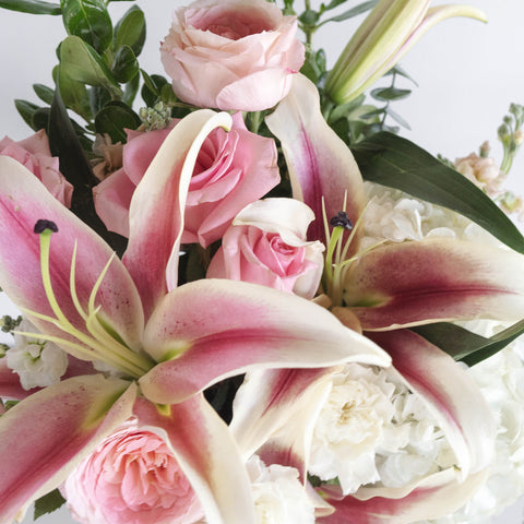 pink and white oriental lilies in a bouquet up close