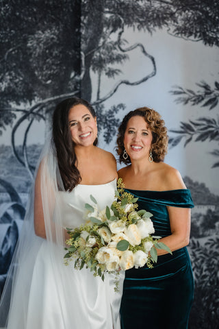 Bride with Mother of the Bride while holding her bridal bouquet