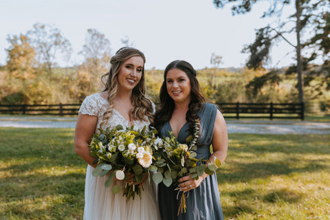 bride with maid of honor holding bouquets