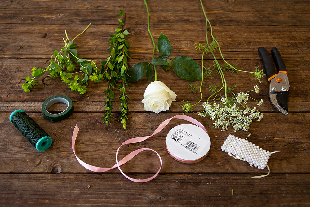 Supplies and flowers needed to create a boutonniere