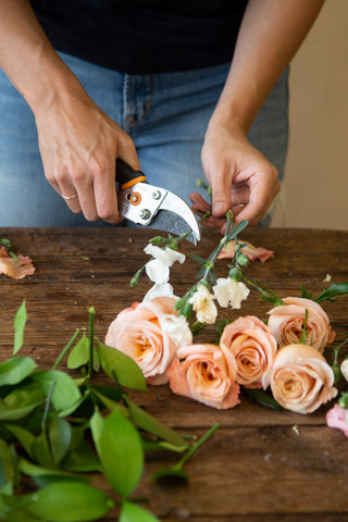 trimming pink and white flowers for a flower crown