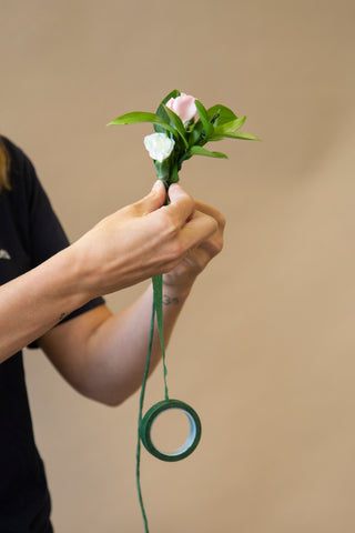 attaching pink and white flowers to base of flower crown