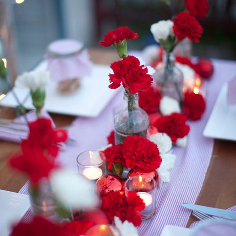 Get Festive This Season with Holiday Flowers red and white carnations on Christmas table