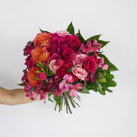 Pink bouquet in hand with pink alstroemerias and roses