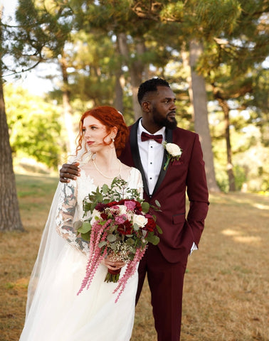 bride and groom standing together looking opposite directions