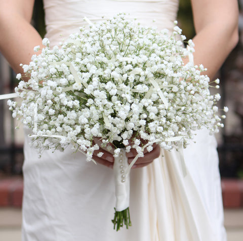 bride holding baby's breath bouquet