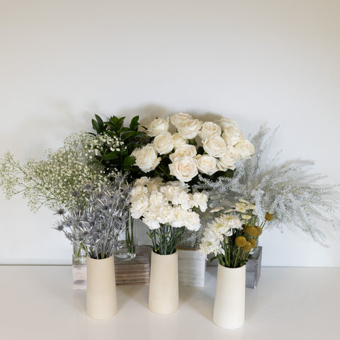 Bouquet bar with white flowers and green and silver accent flowers
