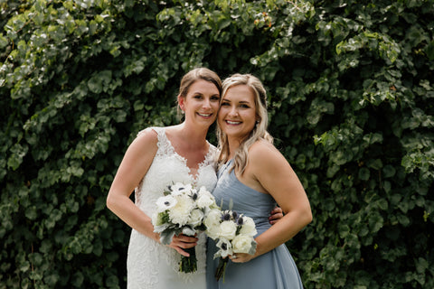 bride with maid of honor holding bouquets