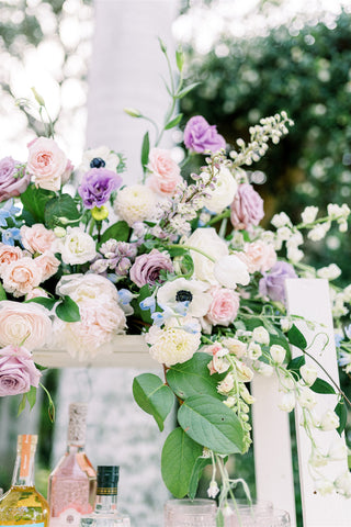 lavender, pink, and white spring flower arrangement at a bridal party