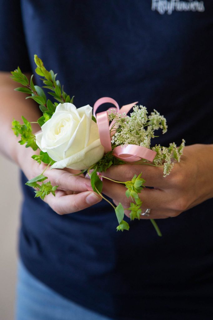 Next, tie and secure a ribbon bow to the middle of your corsage design