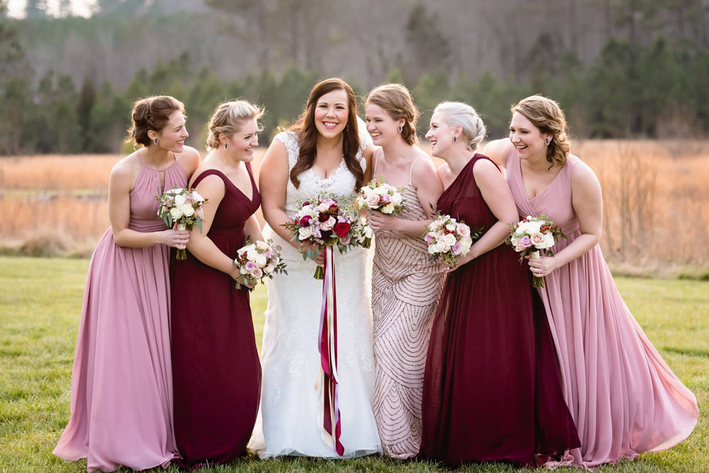 bridesmaids in burgundy hold dainty posy types of wedding bouquets