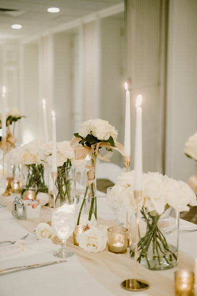 white and ivory flower centerpieces with tall white candles