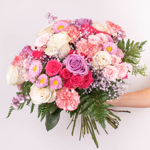 pink and purple flower bouquet with roses and babys breath