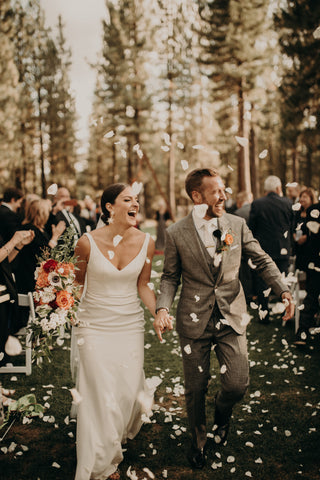 bride and groom walking through rose petals