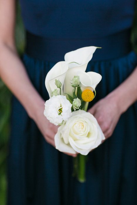 a small and dainty type of wedding bouquet with white rose and white calla lilies