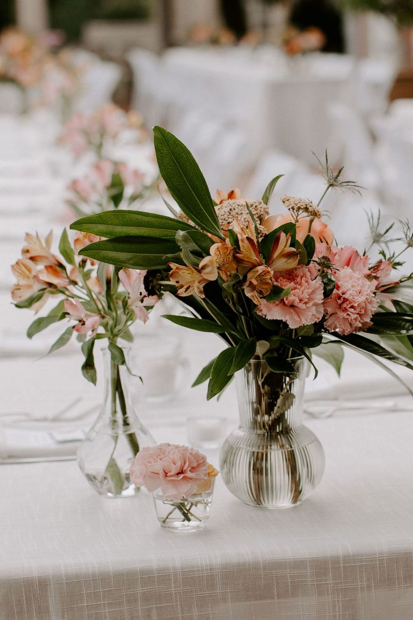 Affordable DIY wedding centerpieces with carnations and alstroemeria, styled in three vase sizes