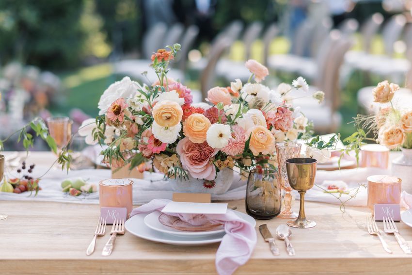 A trending wedding centerpiece with pink, peach, and white flowers