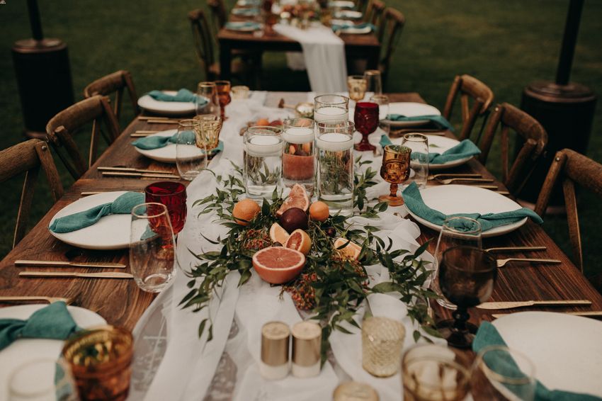 A unique centerpiece idea using greenery, fresh citrus, and floating candles